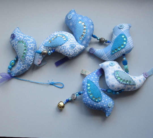 Mobile birds on a wire in cotton with beads, buttons, ribbon and a bell