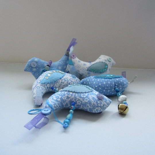 Mobile birds on a wire in cotton with beads, buttons, ribbon and a bell