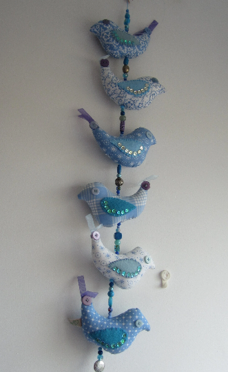 Mobile birds on a wire in cotton with beads, buttons, ribbon and a bell