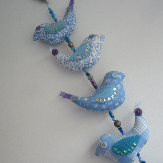 Mobile birds on a wire in cotton with beads, buttons, ribbon and a bell