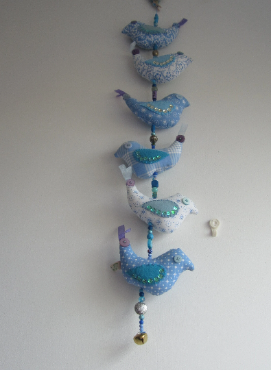 Mobile birds on a wire in cotton with beads, buttons, ribbon and a bell