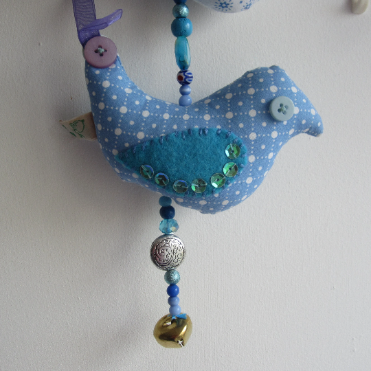 Mobile birds on a wire in cotton with beads, buttons, ribbon and a bell