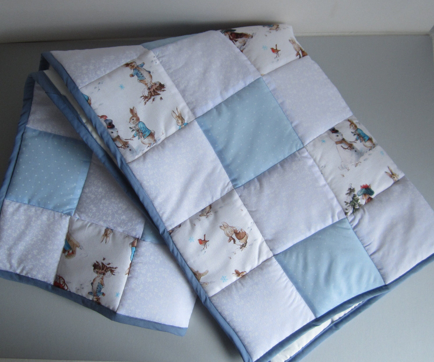 Newborn Baby Christmas Quilt Featuring Peter Rabbit, Benjamin Bunny and Robin Playing in the Snow