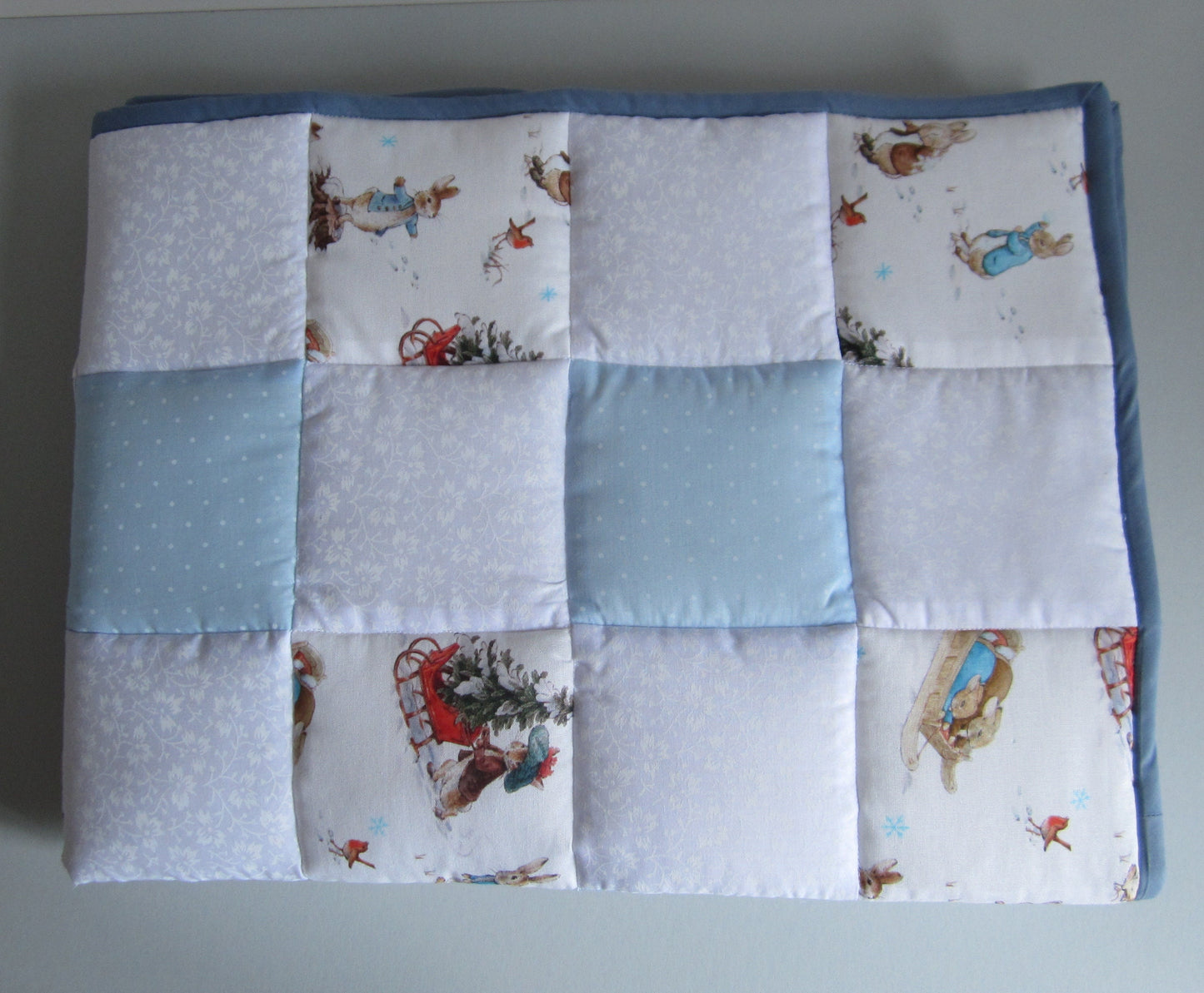 Newborn Baby Christmas Quilt Featuring Peter Rabbit, Benjamin Bunny and Robin Playing in the Snow