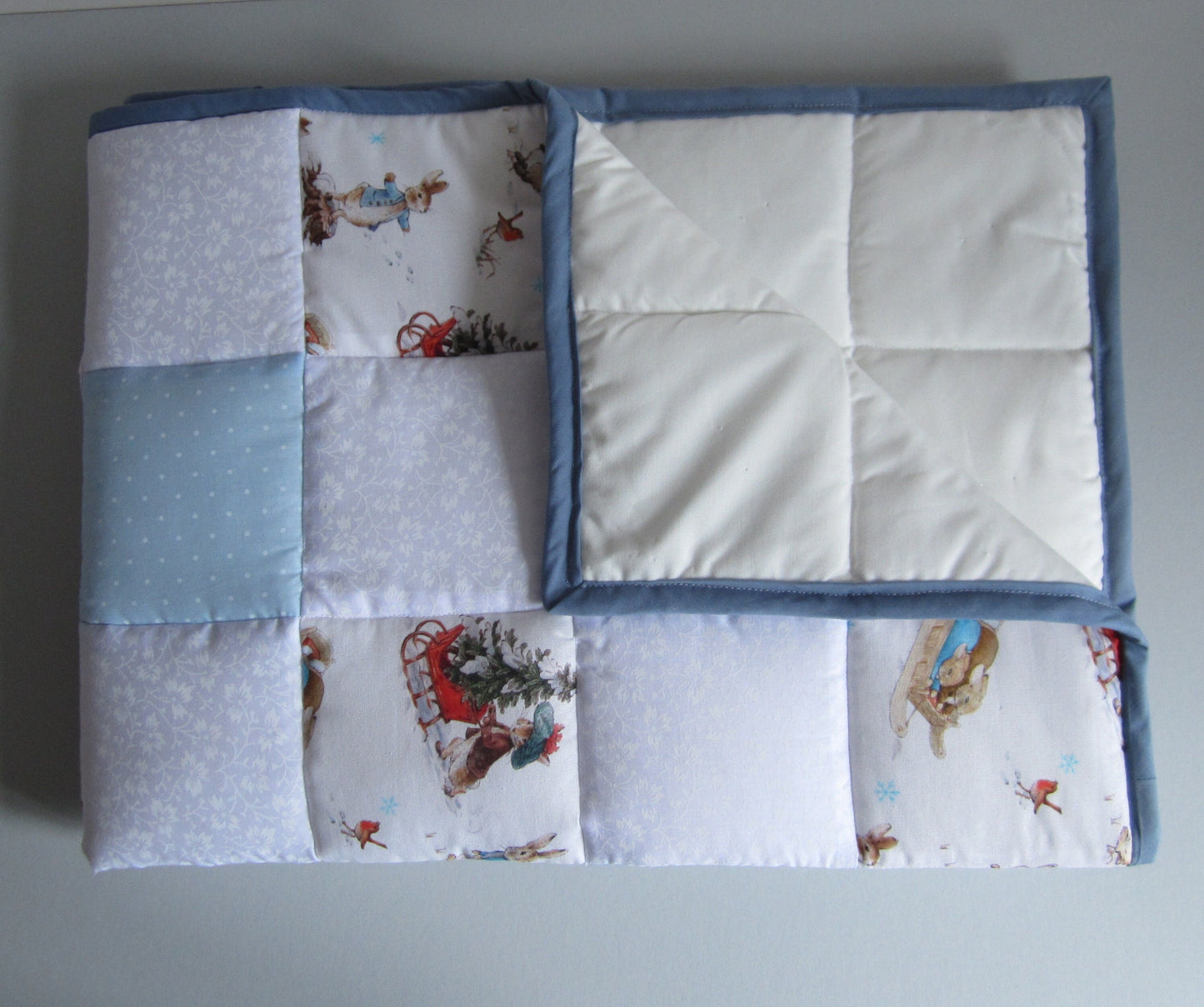 Newborn Baby Christmas Quilt Featuring Peter Rabbit, Benjamin Bunny and Robin Playing in the Snow